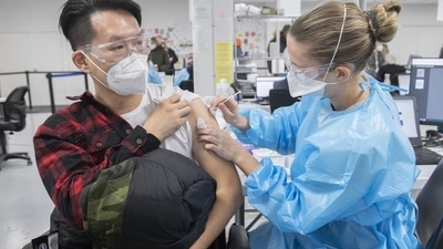 A healthcare worker administers a Covid-19 vaccine at the Decarie Square vaccination site in Montreal, Quebec, Canada. (Bloomberg) A healthcare worker administers a Covid-19 vaccine at the Decarie Square vaccination site in Montreal, Quebec, Canada. (Bloomberg)