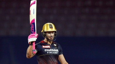 Faf Du Plessis, captain of Royal Challengers Bangalore, raises his bat after scoring a half-century during the 3rd T20 cricket match (PTI)