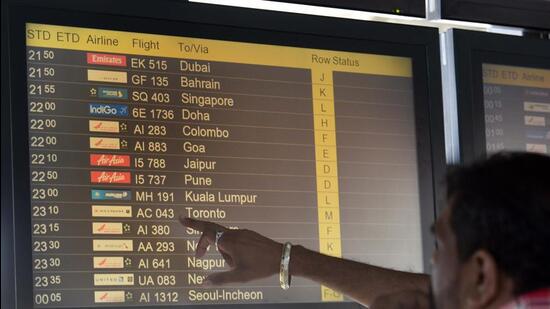 A passenger checks the flight schedule at Terminal 3, Indira Gandhi International (IGI) Airport in New Delhi on Sunday. (Arvind Yadav /HT photo)