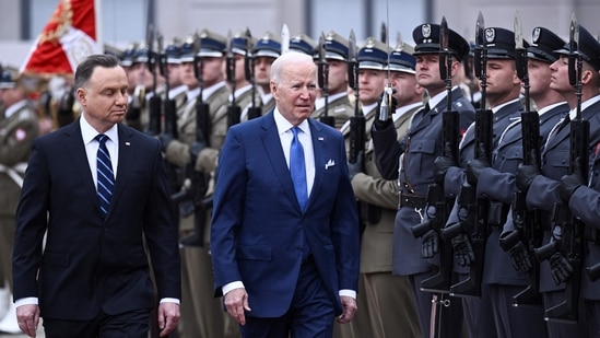 US President Joe Biden (R) and Polish President Andrzej Duda review a military honour guard during an official welcoming ceremony.(AFP)