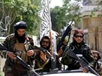 Taliban fighters display their flag on patrol in Kabul, Afghanistan. Taliban fighters display their flag on patrol in Kabul, Afghanistan.