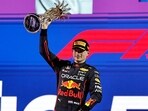 Max Verstappen celebrates on the podium with the trophy after winning the race in Jeddah.(REUTERS)