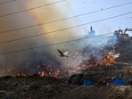 Flames and smoke rise from a fire at Ghazipur Landfill, in New Delhi, Monday.