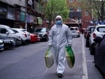 A man wearing a protective suit is seen on a street in Wuhan, Hubei province, the epicentre of China's coronavirus disease.(Reuters)