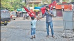A boy assists a strike supporter erect flags at a town square on the first day of two day nationwide strike called by various labor unions in Kochi on Monday. (AP) A boy assists a strike supporter erect flags at a town square on the first day of two day nationwide strike called by various labor unions in Kochi on Monday. (AP)