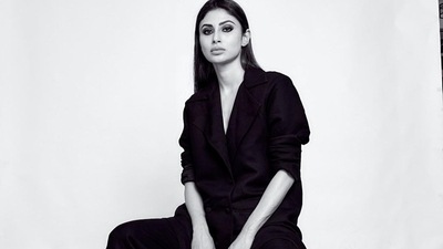 The pictures featured the diva donning a full sleeves black blazer that came with double pockets at the bottom and was buttoned down the waist. Mouni opted to go shirtless to add to the oomph factor and teamed it with a pair of baggy bell-bottom pants that too came in black colour. (Instagram/imouniroy) The pictures featured the diva donning a full sleeves black blazer that came with double pockets at the bottom and was buttoned down the waist. Mouni opted to go shirtless to add to the oomph factor and teamed it with a pair of baggy bell-bottom pants that too came in black colour. (Instagram/imouniroy)