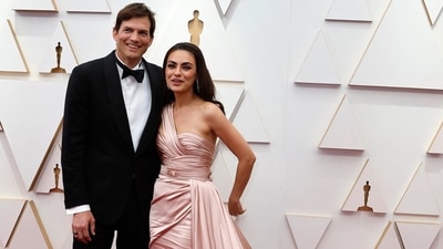 Ashton Kutcher and Mila Kunis posed on the red carpet during the Oscars arrivals in simple and elegant looks. Mila stunned in a baby pink floor-sweeping gown, and Ashton wore a black tuxedo. The couple served ultimate date night outfit goals with their ensembles. (REUTERS)