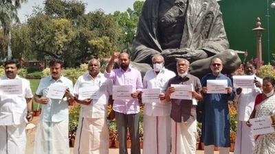 MPs standing in front of the Gandhi statue holding placards. (ANI)