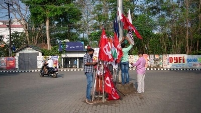 Strike supporters erect flags at a traffic intersection on the first day of atwo-day nationwide strike in Kochi. (AP) Strike supporters erect flags at a traffic intersection on the first day of atwo-day nationwide strike in Kochi. (AP)