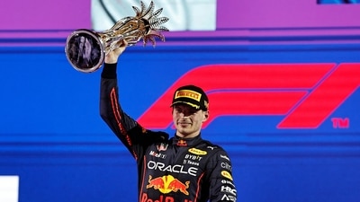 Max Verstappen celebrates on the podium with the trophy after winning the race in Jeddah. (REUTERS)