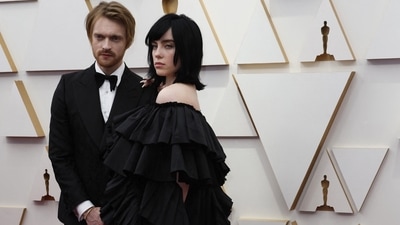Billie Eilish and her brother Finneas O'Connell won the original-song Oscar for No Time to Die, the title tune for the latest James Bond film, at Sunday's 94th annual Academy Awards. The singer wore a dramatic black Gucci gown decorated with row upon row of ruffles. Finneas accompanied his sister in a black tuxedo. 
