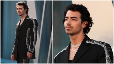 Underneath, the singer opted for a black round neck top that provided a clean finish. He rounded off the look with black high-heeled boots, black nail paint, rings, a silver choker chain, messy hairdo and rugged beard. (AP) Underneath, the singer opted for a black round neck top that provided a clean finish. He rounded off the look with black high-heeled boots, black nail paint, rings, a silver choker chain, messy hairdo and rugged beard. (AP)