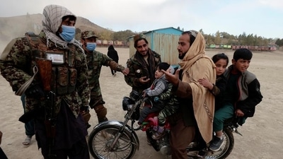 Taliban fighters talk to a man riding a motorcycle with his children as they visit the amusement park at Kabul’s Qargha reservoir, Afghanistan. (Reuters / File) Taliban fighters talk to a man riding a motorcycle with his children as they visit the amusement park at Kabul’s Qargha reservoir, Afghanistan. (Reuters / File)