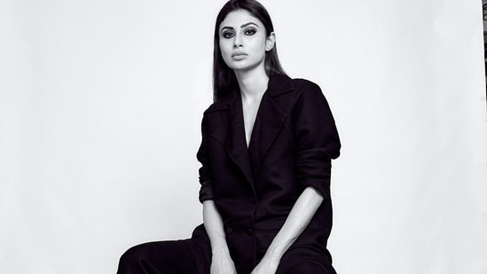 The pictures featured the diva donning a full sleeves black blazer that came with double pockets at the bottom and was buttoned down the waist. Mouni opted to go shirtless to add to the oomph factor and teamed it with a pair of baggy bell-bottom pants that too came in black colour.&nbsp;(Instagram/imouniroy)