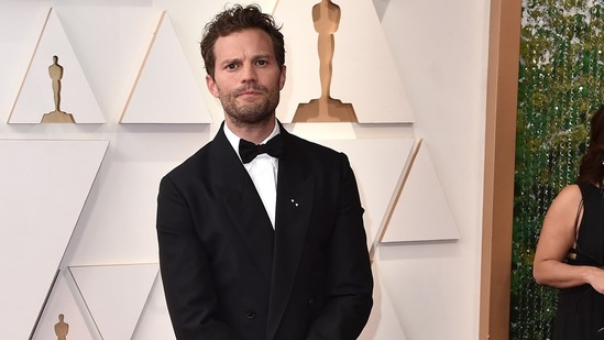 Jamie Dornan, who stars in the seven-times nominated drama Belfast, looked handsome in a black tuxedo. The star even shared a kiss with his roommate Andrew Garfield on the red carpet, and the moment instantly went viral.(Jordan Strauss/Invision/AP)