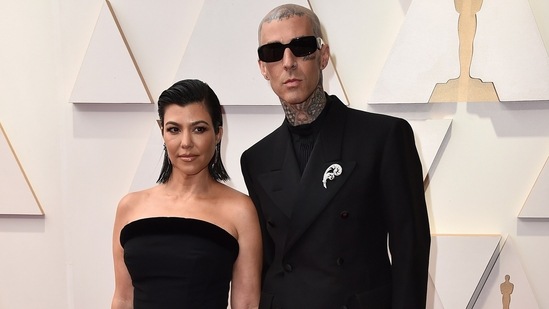 Kourtney Kardashian and Travis Barker served major PDA moments at the Oscars ceremony. The Keeping Up With Kardashian star and the Blink-182 drummer chose classic all-black ensembles. She wore a strapless mid-length dress with heels, while Travis wore a crisp black suit.(Jordan Strauss/Invision/AP)