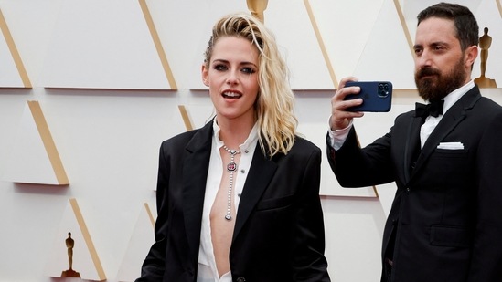 Spencer actor Kristen Stewart created an iconic moment on the Oscars' red carpet as she ditched floor-sweeping gown for an effortless and chic Chanel look. She wore an &nbsp;unbuttoned shirt, hot shorts and a cropped blazer.&nbsp;(REUTERS)