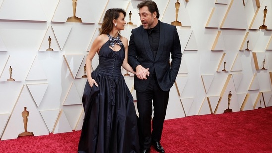 Penelope Cruz and husband Javier Bardem were couple goals on the Oscars red carpet. Penelope stepped out in a custom long taffeta Chanel dress with an open back, while Javier selected a monochromatic tux for their big night out. Her gown was inspired by Chanel's Haute Couture Fall-Winter 2020/21 collection.(REUTERS)