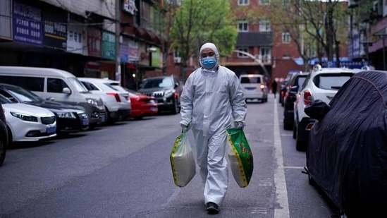 A man wearing a protective suit is seen on a street in Wuhan, Hubei province, the epicentre of China's coronavirus disease.(Reuters)