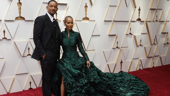 Will Smith, who won the Best Actor Oscar for his role in King Richard, and Jada Pinkett Smith continued their style reign at 94th Academy Awards. Will sported a Dolce and Gabbana black mohair wool tuxedo, and Jada made her way down the red carpet in a Jean Paul Gaultier SS22 Couture gown, complete with a high neck and dramatic ruffled skirt.(Reuters)