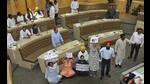 AAP councillors demanding a debate on the water tariff hike issue in the well of the MC House during a meeting in Chandigarh on Tuesday. (Keshav Singh/HT) AAP councillors demanding a debate on the water tariff hike issue in the well of the MC House during a meeting in Chandigarh on Tuesday. (Keshav Singh/HT)