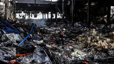 A rescuer clears the rubble of a warehouse containing more than 50,000 tons of deep-frozen food in the town of Brovary, north of Ukrainian capital of Kyiv, after being destroyed by a Russian shelling. (AFP) A rescuer clears the rubble of a warehouse containing more than 50,000 tons of deep-frozen food in the town of Brovary, north of Ukrainian capital of Kyiv, after being destroyed by a Russian shelling. (AFP)
