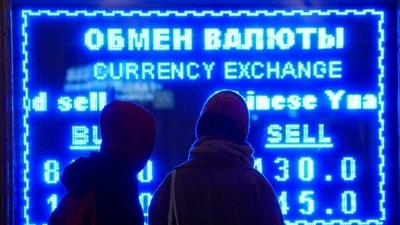 Women look at a screen displaying exchange rate at a currency exchange office in St. Petersburg, Russia. (AP)