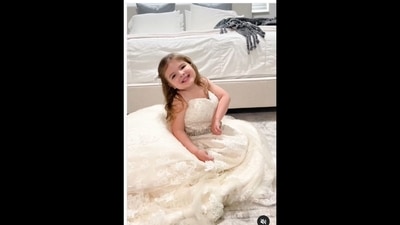 The little girl wore her mother's wedding gown and it is adorable to watch. (kay.buell/Instagram) The little girl wore her mother's wedding gown and it is adorable to watch. (kay.buell/Instagram)