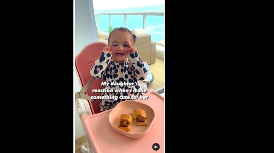 The little girl reacts adorably to her mother as she gives her a sweet treat. (natalieandbruna/Instagram)