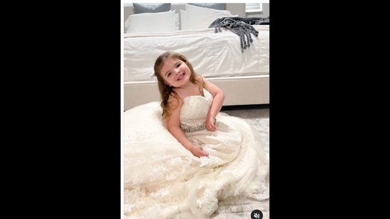 Toddler wears her mother's wedding gown. Video will melt your