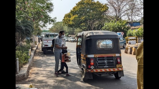 A passenger is seen requesting a ride from an auto driver outside Pune’s Lohegaon airport on Tuesday. (Shankar Narayan/HT PHOTO)