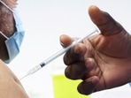 FILE PHOTO: A man receives a booster dose of Pfizer's coronavirus disease.