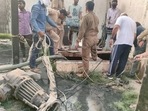 Firefighters and plant workers during a rescue operation after two workers fell into a pit of a sewage plant of the Delhi Jal Board, at Dallupura in New Delhi, Wednesday, March 30, 2022. (PTI Photo) Firefighters and plant workers during a rescue operation after two workers fell into a pit of a sewage plant of the Delhi Jal Board, at Dallupura in New Delhi, Wednesday, March 30, 2022. (PTI Photo)