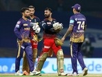 Dinesh Karthik and Harshal Patel of Royal Challengers Bangalore with Kolkata Knight Riders players after winning the match(PTI)