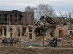 Local walks past buildings damaged by shelling, as Russia’s attack on Ukraine continues, REUTERS/Oleg Pereverzev