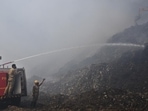 Firefighters douse a fire at the Ghazipur landfill site, in on Tuesday. (Ajay Aggarwal /HT)
