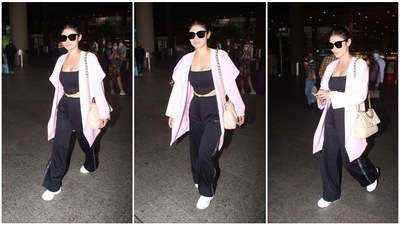 Mouni Roy keeps travelling back and forth from India to Dubai, where her husband Suraj Nambiar is based. She recently landed in Mumbai and was snapped by the shutterbugs. Her airport look comprised of a black co-ord set paired with a pink baggy jacket. (HT Photo/Varinder Chawla) Mouni Roy keeps travelling back and forth from India to Dubai, where her husband Suraj Nambiar is based. She recently landed in Mumbai and was snapped by the shutterbugs. Her airport look comprised of a black co-ord set paired with a pink baggy jacket. (HT Photo/Varinder Chawla)