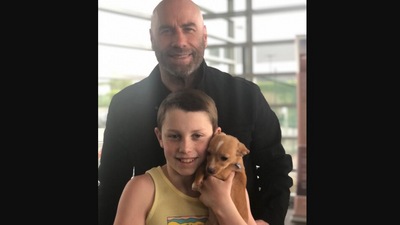 The image, taken from Instagram shows John Travolta and his son with the dog from Betty White’s tribute at Oscars. (Instagram/@johntravolta)