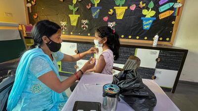 A healthcare worker administers a dose of the Covid-19 vaccine to a student in the age group of 12-14 years, at a school in Vasundhara, in Ghaziabad on Wednesday. (PTI)