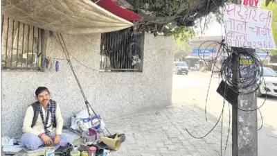 The centrepiece of this setting is shoe repairer Bansi, perched behind his modest stall, in Gurugram’s Sector 19, near Krishna Chowk. (Mayank Austen Soofi) The centrepiece of this setting is shoe repairer Bansi, perched behind his modest stall, in Gurugram’s Sector 19, near Krishna Chowk. (Mayank Austen Soofi)