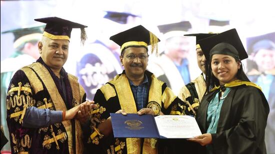 Delhi chief minister Arvind Kejriwal and deputy chief minister Manish Sisodia hand over a degree to a student during the 14th Convocation of Guru Gobind Singh Indraprastha University in New Delhi on Wednesday. (Vipin Kumar/HT Photo)