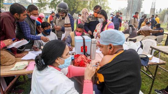 Election duty official receives a booster dose of Covishield vaccine, ahead of upcoming UP Assembly elections at a training center, in Prayagraj on February 4. (PTI)