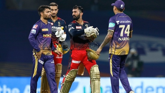 Dinesh Karthik and Harshal Patel of Royal Challengers Bangalore with Kolkata Knight Riders players after winning the match(PTI)