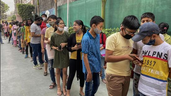 Students in the age group of 12-14 years, wait in a queue to get a dose of the Covid-19 preventive vaccine, at a school in Vasundhara, in Ghaziabad on Wednesday. (PTI)