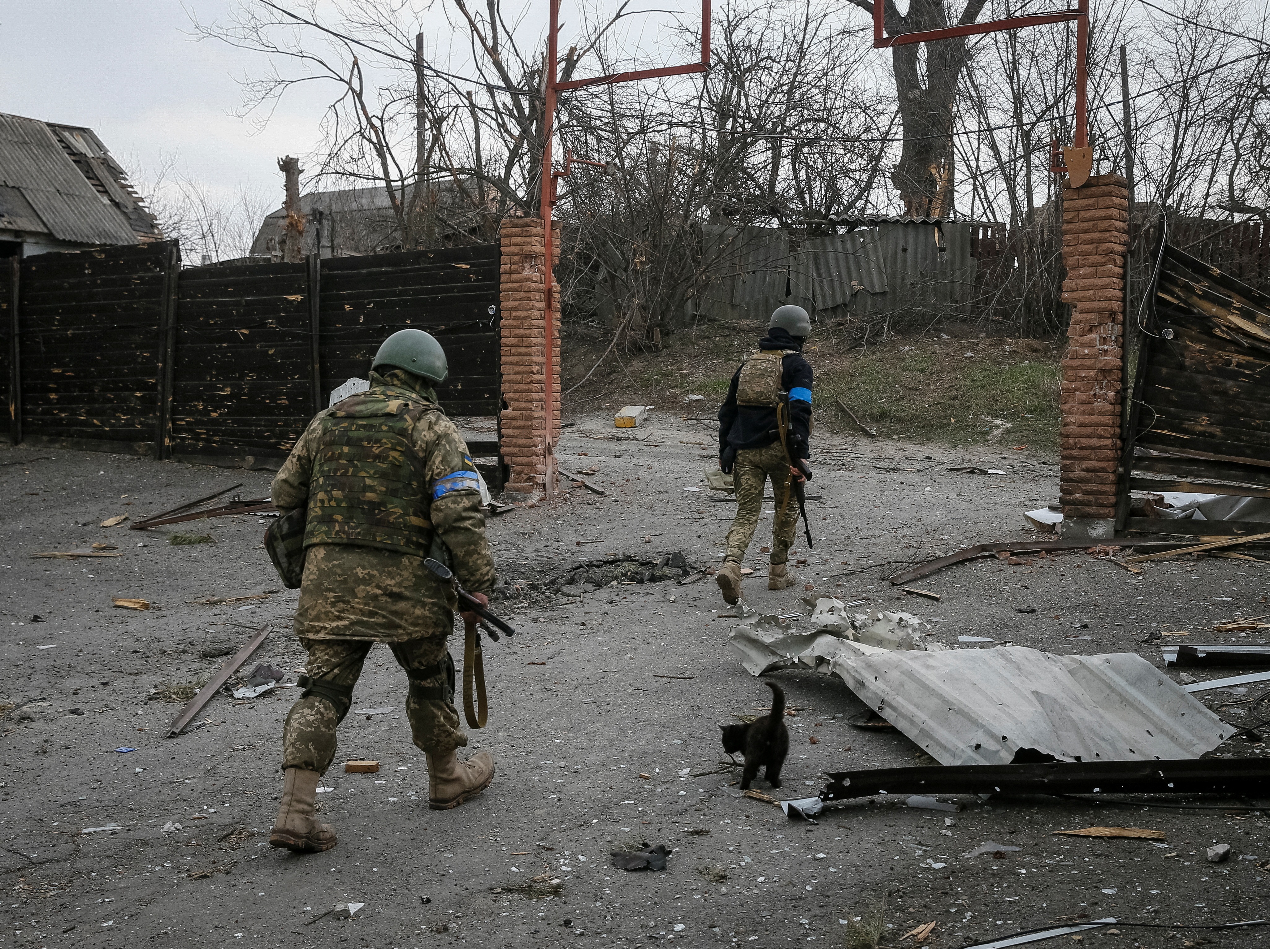 Ukrainian service members walk on the front line near Kyiv as Russia's invasion of Ukraine continues, on March 29, 2022.&nbsp; (Reuters)