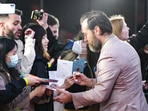 Jude Law signs autographs upon arrival at the world premiere of the film Fantastic Beasts: The Secrets of Dumbledore in London Tuesday.(AP)