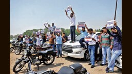 Youth Congress workers holding up signs criticising government during a protest in Chandigarh over the hike in fuel prices. (HT Photo)