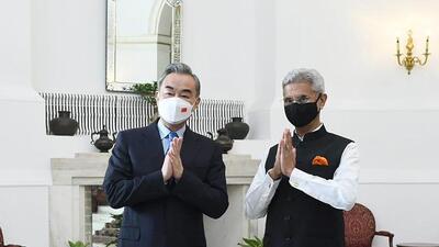 Indian Foreign Minister S. Jaishankar and his Chinese counterpart Wang Yi greet the media before their meeting in New Delhi, India, on March 25. (AP)