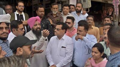 Shopkeepers objecting to road level as MLA Madan Lal Bagga reached Chander Nagar area for inaugurating road construction work in Ludhiana on March 31, 2022. (HT PHOTO) Shopkeepers objecting to road level as MLA Madan Lal Bagga reached Chander Nagar area for inaugurating road construction work in Ludhiana on March 31, 2022. (HT PHOTO)
