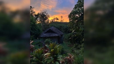 Katrina Kaif also shared a photo of a picturesque location featuring a small hut with green surroundings and mesmerising sunset hues in the backdrop. (Instagram/@katrinakaif)